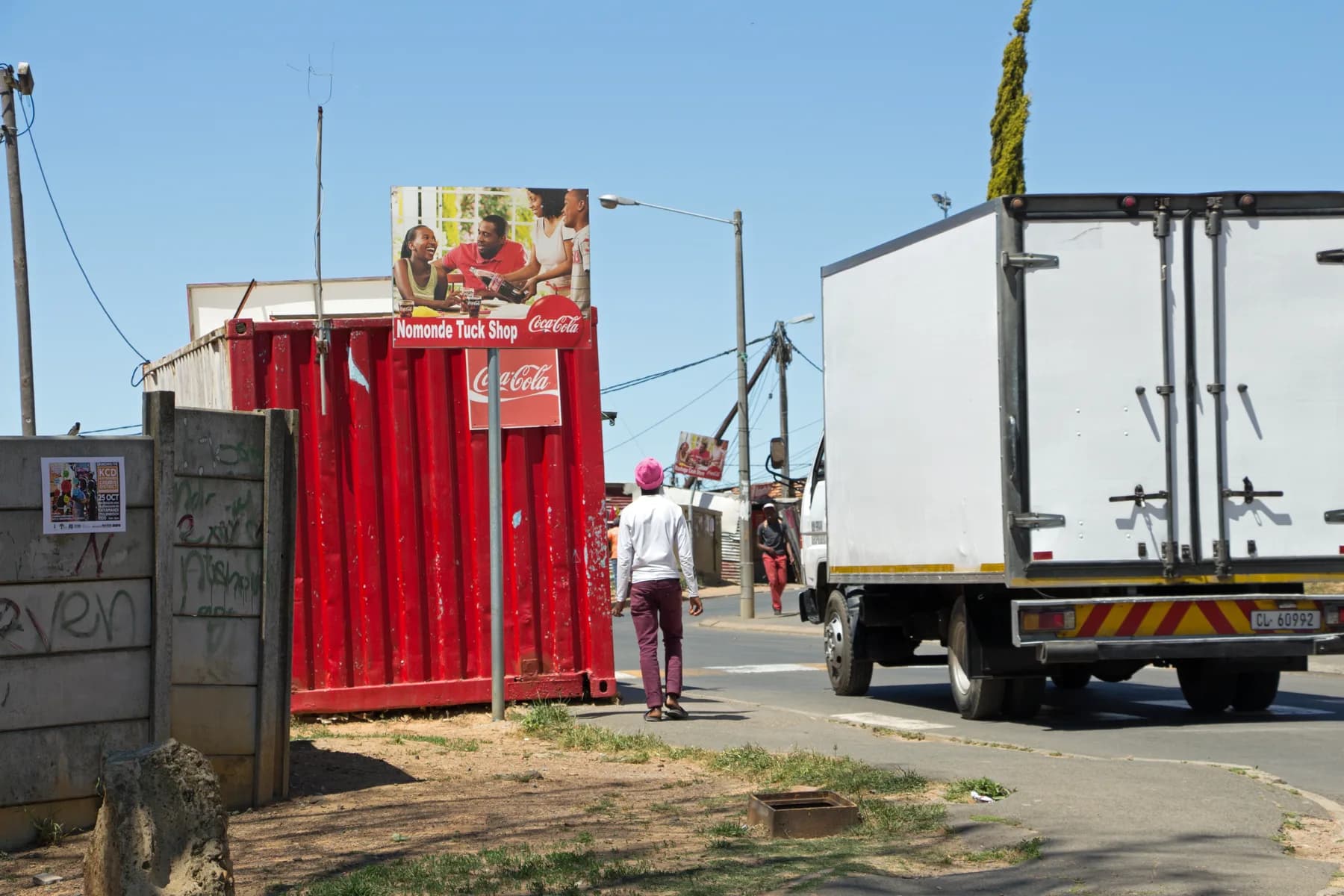 The Nomonde Tuck Shop, painted red, on a Kayamandi corner