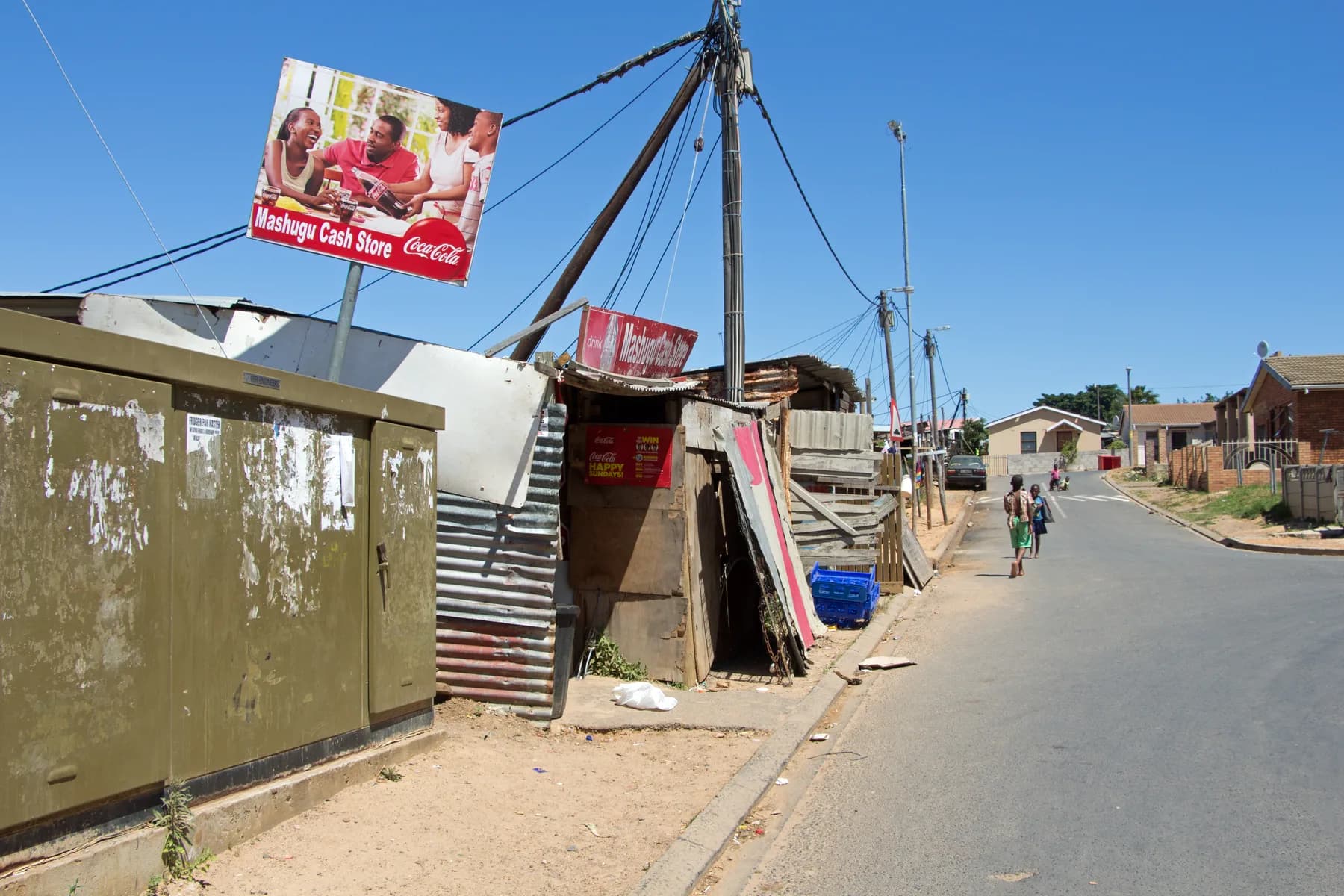 Children walking down a Kayamandi street past the Mashugu Cash Store