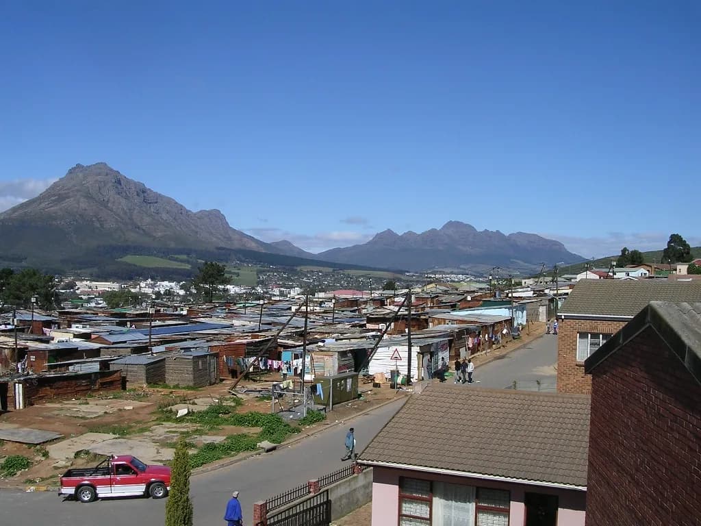 Kayamandi seen from a rooftop, its roofs running towards the mountains