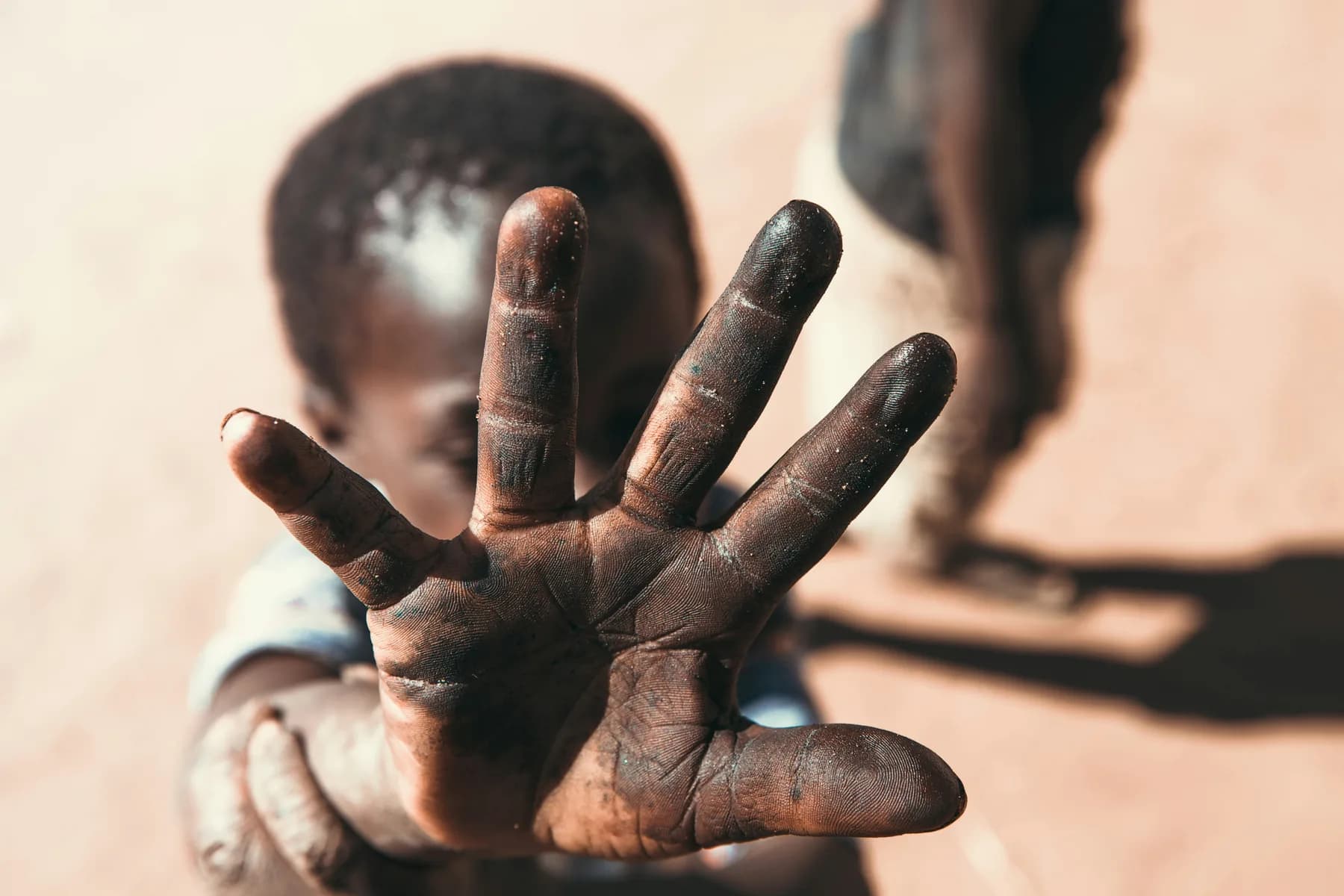 A child's open hand held out towards the camera
